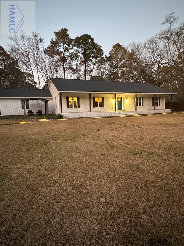 ranch-style home with a front lawn and brick siding