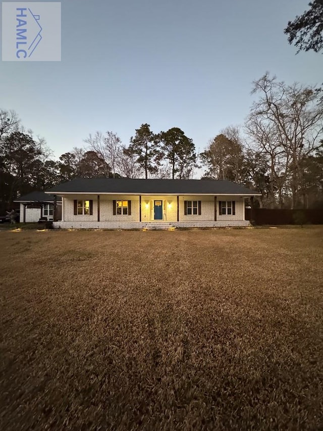 view of front of house with brick siding and a front yard