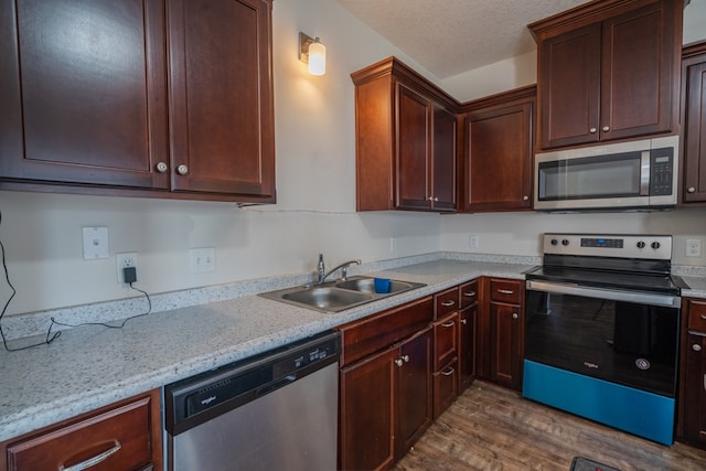 361 Thorp Cir, Hinesville, GA 31313 - kitchen with hardwood / wood-style floors, sink, stainless steel appliances, light stone countertops, and a textured ceiling