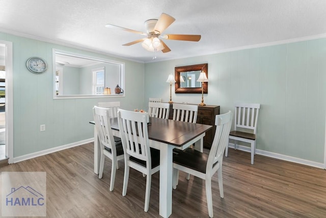 dining space with a textured ceiling, hardwood / wood-style flooring, ceiling fan, and crown molding