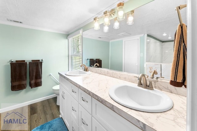 bathroom featuring hardwood / wood-style floors, vanity, a shower, toilet, and ornamental molding