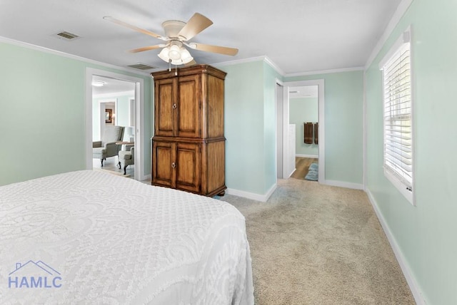 bedroom featuring connected bathroom, light colored carpet, ceiling fan, and crown molding