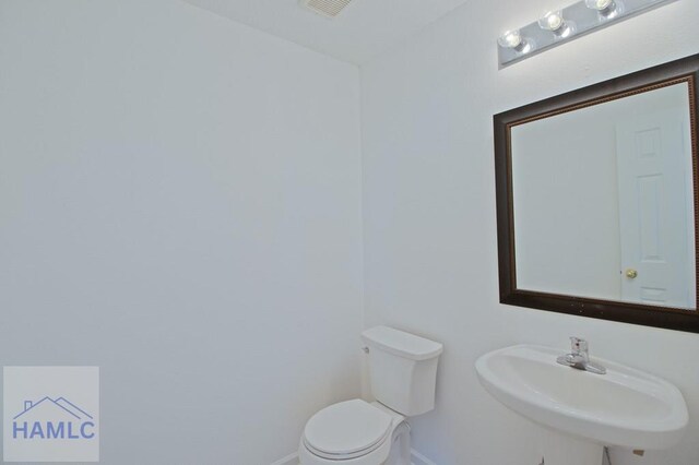 1 Blackberry Ln, Port Wentworth, GA 31407 - bathroom with baseboards, toilet, and a sink