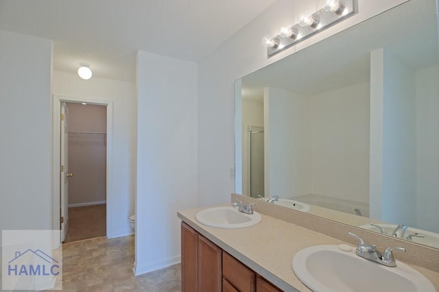 1 Blackberry Ln, Port Wentworth, GA 31407 - full bathroom featuring double vanity, a walk in closet, toilet, baseboards, and a shower