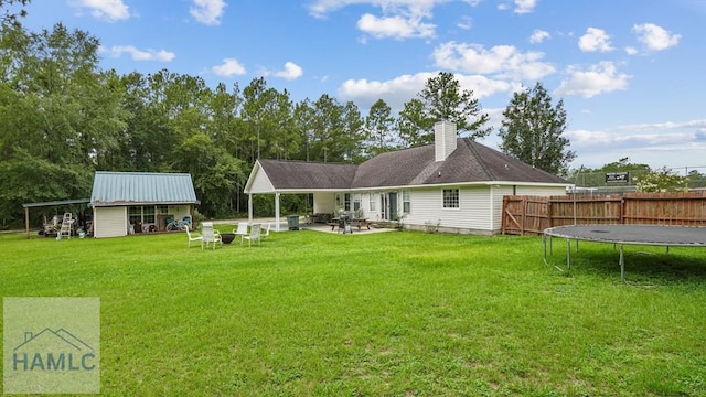 705 S 11th St, Jesup, GA 31545 - rear view of property with a patio area, a chimney, and an outdoor structure