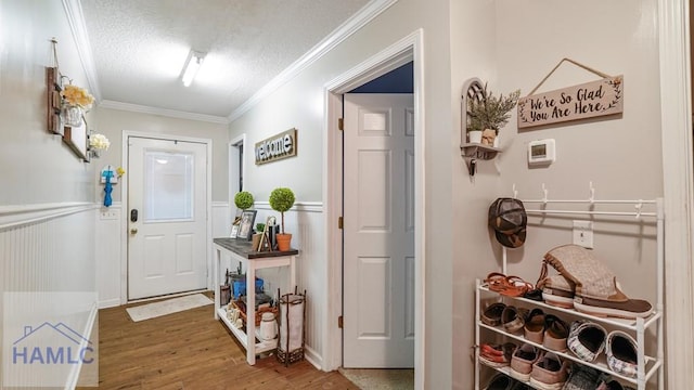 705 S 11th St, Jesup, GA 31545 - entrance foyer with wood finished floors, ornamental molding, a textured ceiling, and a wainscoted wall