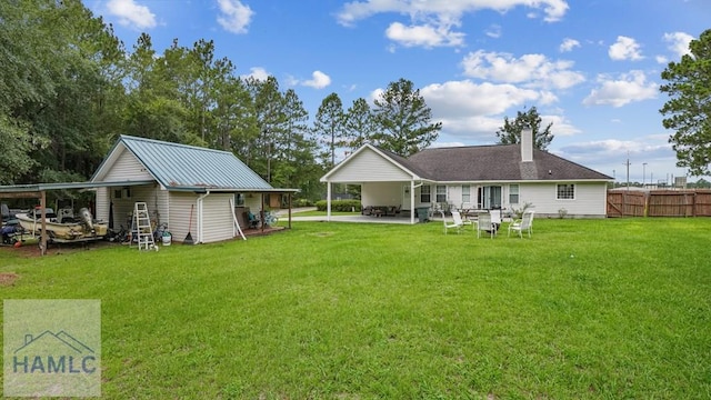 705 S 11th St, Jesup, GA 31545 - back of house featuring a carport, a chimney, and a patio area