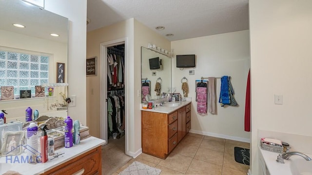 705 S 11th St, Jesup, GA 31545 - full bathroom with vanity, tile patterned floors, a garden tub, a walk in closet, and a textured ceiling