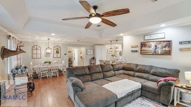 705 S 11th St, Jesup, GA 31545 - living room with a tray ceiling, a ceiling fan, recessed lighting, ornamental molding, and light wood-style floors