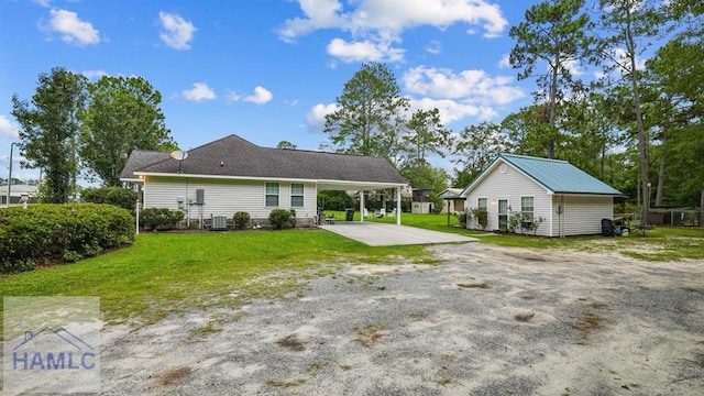 705 S 11th St, Jesup, GA 31545 - rear view of house featuring an attached carport, a lawn, a patio, and driveway
