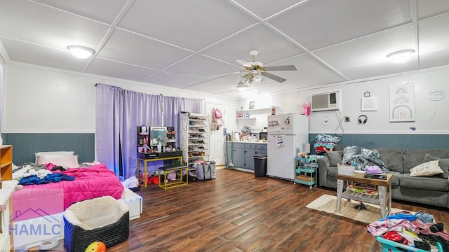 705 S 11th St, Jesup, GA 31545 - bedroom with freestanding refrigerator, a wainscoted wall, a wall mounted AC, dark wood-type flooring, and ceiling fan