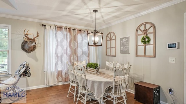 705 S 11th St, Jesup, GA 31545 - dining room featuring plenty of natural light, wood-type flooring, ornamental molding, and a chandelier