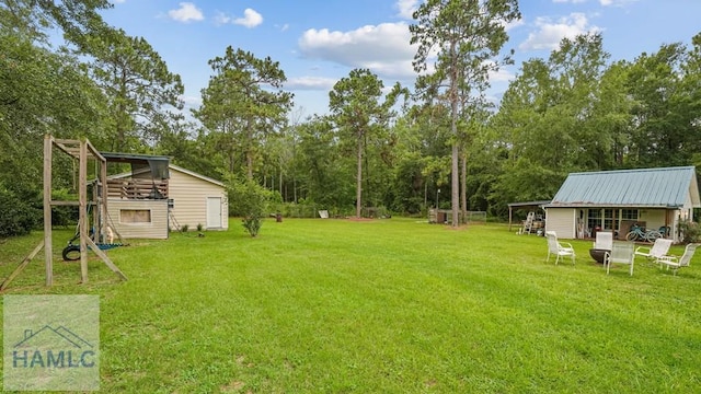 705 S 11th St, Jesup, GA 31545 - view of green lawn with an outdoor structure
