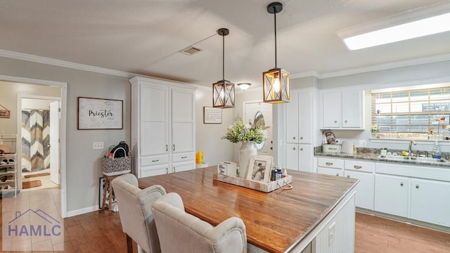 705 S 11th St, Jesup, GA 31545 - dining room featuring wood finished floors and crown molding