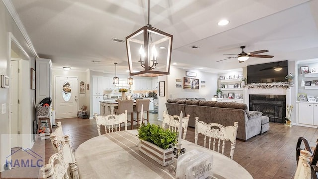 705 S 11th St, Jesup, GA 31545 - dining room featuring ornamental molding, ceiling fan, a fireplace, dark wood-type flooring, and recessed lighting
