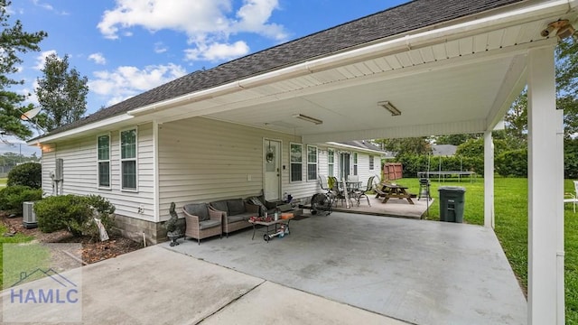 705 S 11th St, Jesup, GA 31545 - view of patio / terrace with a trampoline, a carport, and an outdoor living space