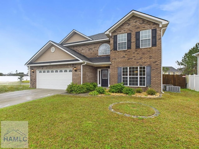 traditional-style home with a front yard, fence, driveway, an attached garage, and brick siding