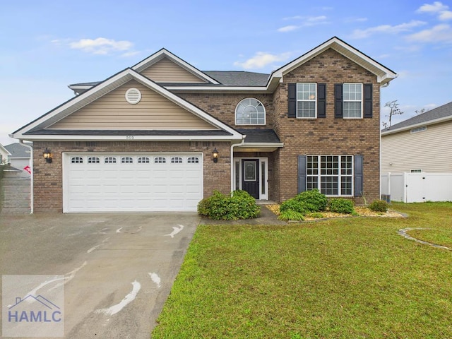 traditional home featuring brick siding, concrete driveway, a front yard, and fence