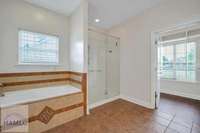 bathroom featuring plus walk in shower and tile patterned flooring