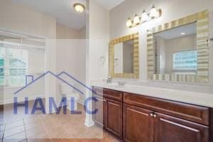 bathroom with tile patterned flooring and vanity