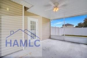 unfurnished sunroom featuring ceiling fan