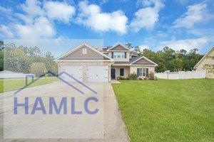 view of front of home featuring a garage and a front lawn