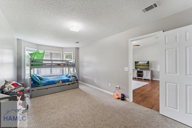 1105 Apache Aly, Hinesville, GA 31313 - carpeted bedroom featuring a textured ceiling and baseboards