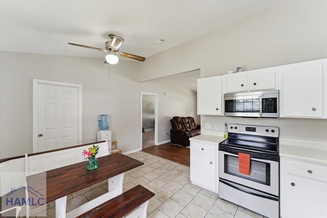 1105 Apache Aly, Hinesville, GA 31313 - kitchen featuring appliances with stainless steel finishes, ceiling fan, light countertops, white cabinetry, and lofted ceiling