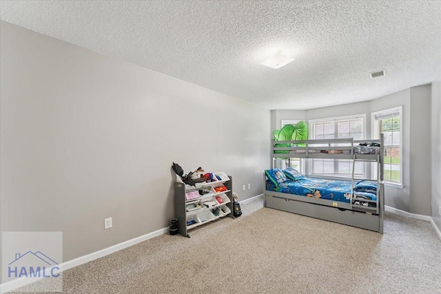 1105 Apache Aly, Hinesville, GA 31313 - carpeted bedroom with a textured ceiling and baseboards