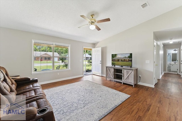 1105 Apache Aly, Hinesville, GA 31313 - living area featuring ceiling fan, dark wood-type flooring, lofted ceiling, and a textured ceiling