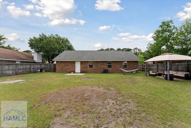 1105 Apache Aly, Hinesville, GA 31313 - back of house featuring an outdoor hangout area, a gazebo, a fenced backyard, and brick siding