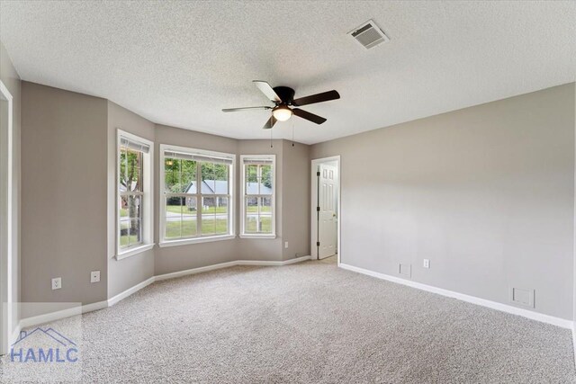 1105 Apache Aly, Hinesville, GA 31313 - empty room featuring a ceiling fan, a textured ceiling, and light carpet
