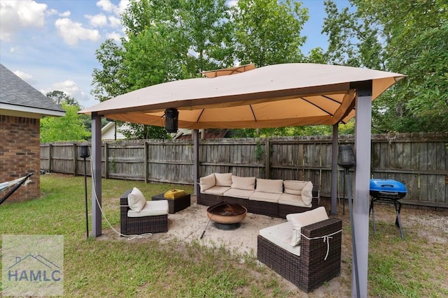1105 Apache Aly, Hinesville, GA 31313 - fenced backyard with a gazebo, an outdoor living space with a fire pit, a patio area, and a grill