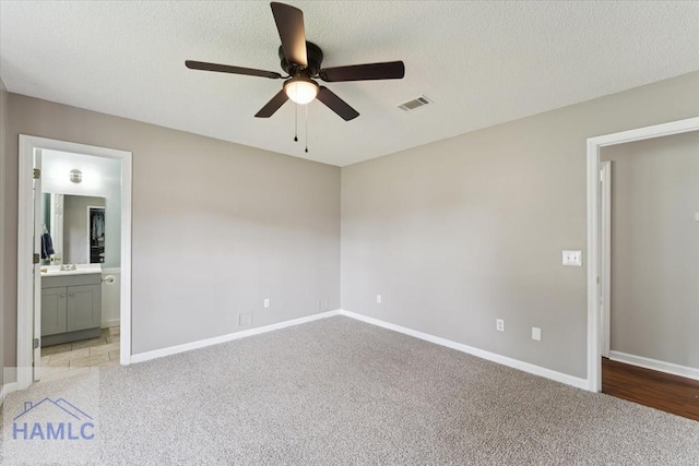1105 Apache Aly, Hinesville, GA 31313 - unfurnished bedroom featuring carpet, ensuite bath, ceiling fan, and a textured ceiling