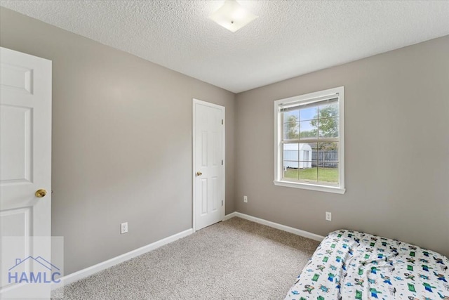 1105 Apache Aly, Hinesville, GA 31313 - carpeted bedroom featuring baseboards and a textured ceiling