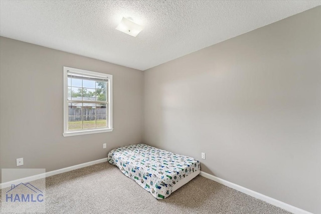 1105 Apache Aly, Hinesville, GA 31313 - bedroom featuring carpet flooring and a textured ceiling