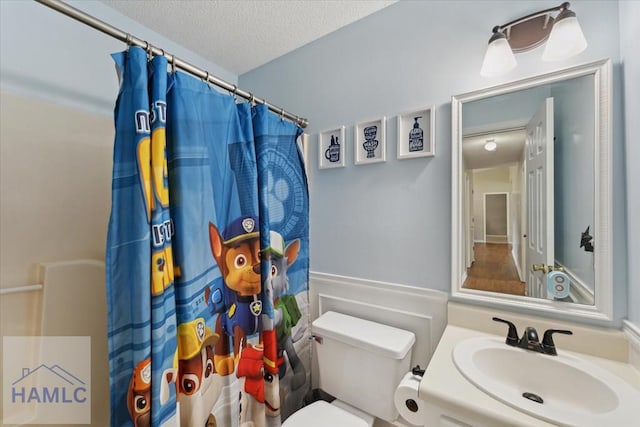 1105 Apache Aly, Hinesville, GA 31313 - bathroom with a textured ceiling, a shower with shower curtain, and vanity