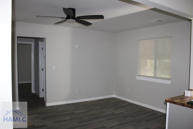 empty room featuring ceiling fan and dark hardwood / wood-style flooring