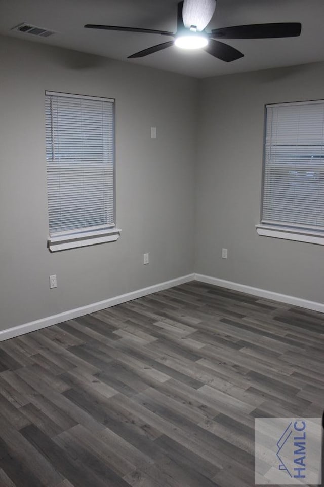 empty room with dark hardwood / wood-style flooring