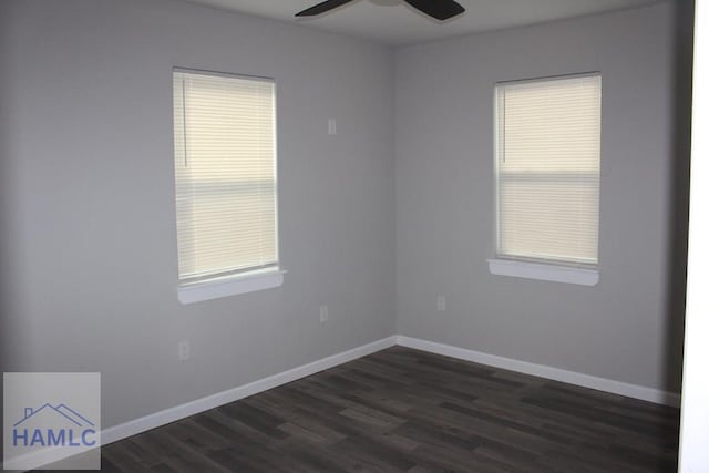 empty room featuring ceiling fan and dark wood-type flooring