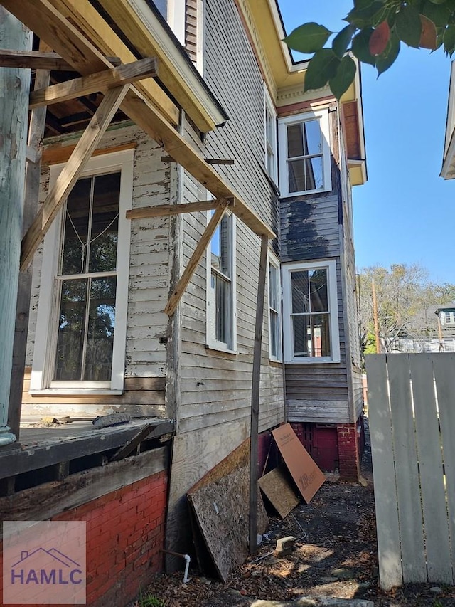 view of side of property featuring fence