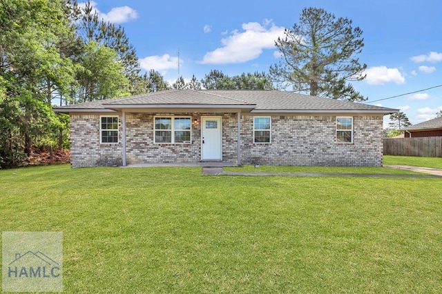 single story home with brick siding, a front lawn, and fence
