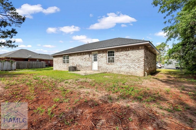back of house with fence, a patio, brick siding, central air condition unit, and a yard