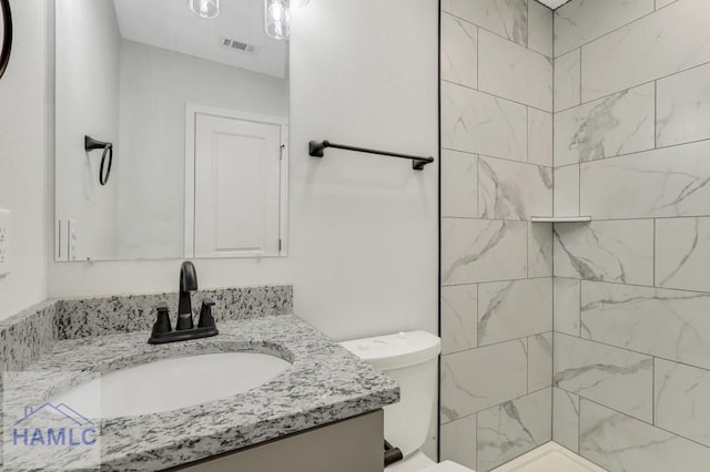 30 Cypress Cv NE, Ludowici, GA 31316 - bathroom with vanity, toilet, tiled shower, and visible vents