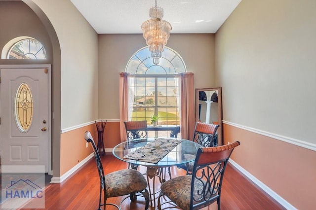 dining room featuring hardwood / wood-style flooring and an inviting chandelier