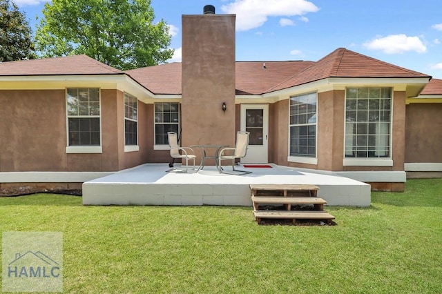 back of house featuring a yard and a patio