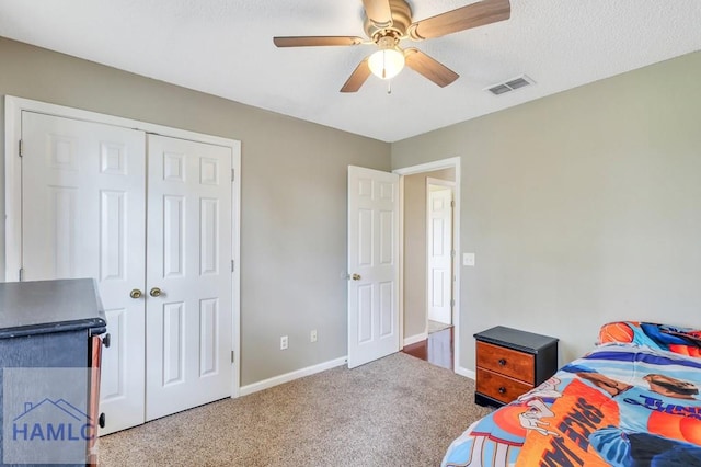 carpeted bedroom with a closet and ceiling fan