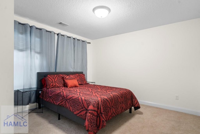 carpeted bedroom with a textured ceiling