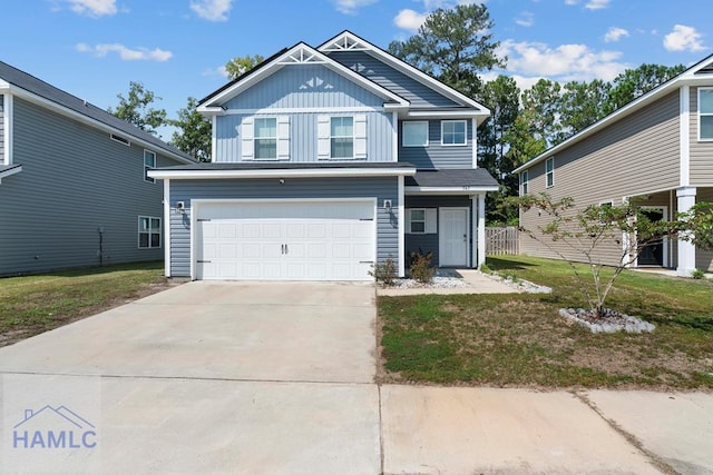 view of front of house with a front yard and a garage