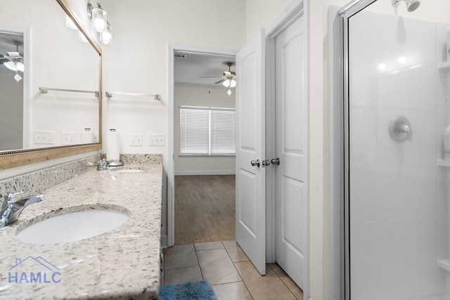 bathroom with an enclosed shower, vanity, hardwood / wood-style flooring, and ceiling fan